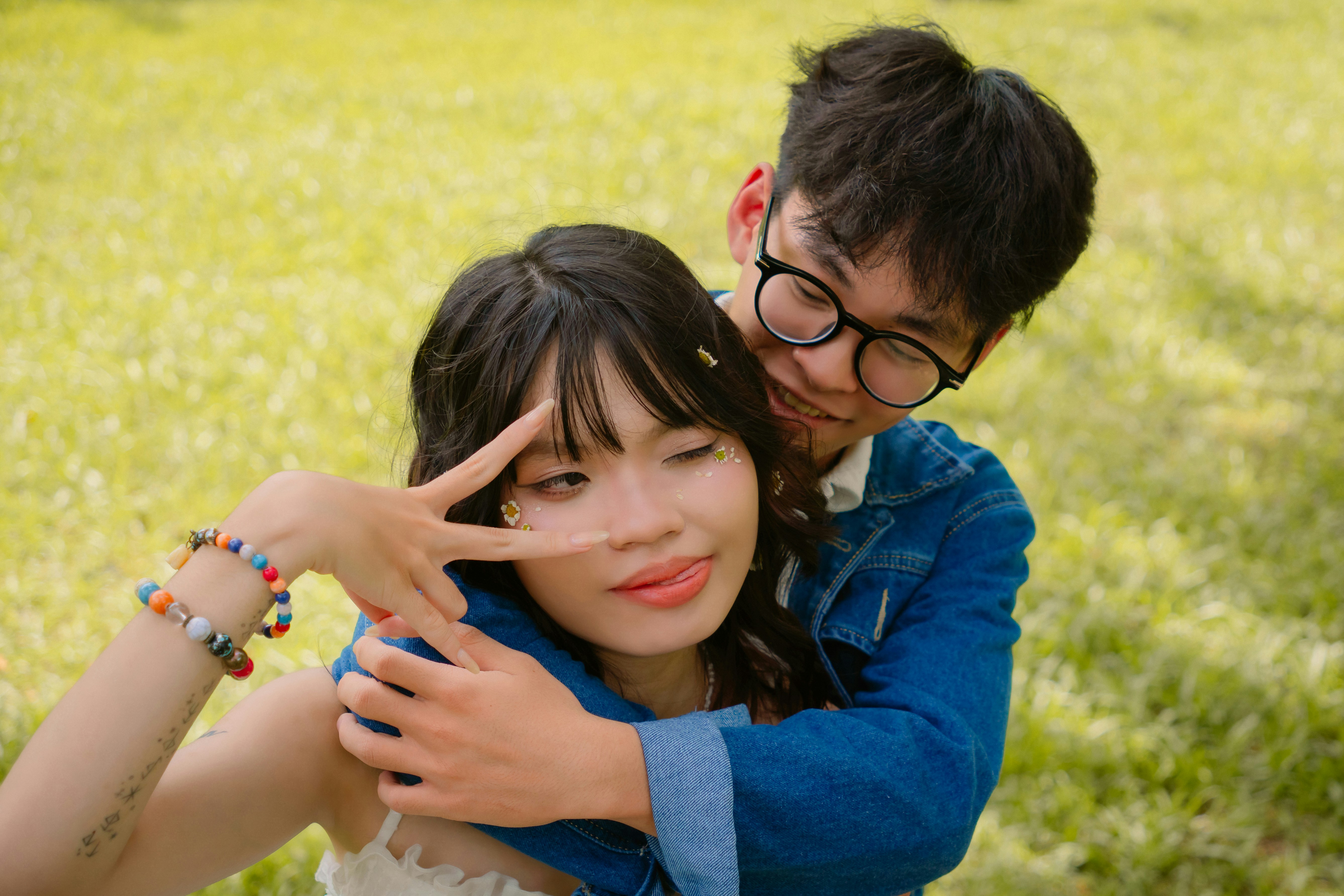 Young couple embracing in a grassy field